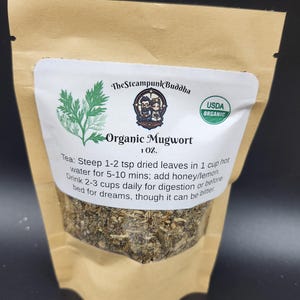 May include: A kraft paper bag containing organic mugwort tea. The label features the text "The Steampunk Buddha" and "Organic Mugwort." The label also includes the USDA Organic seal and instructions for use. The bag contains 1 oz of tea.