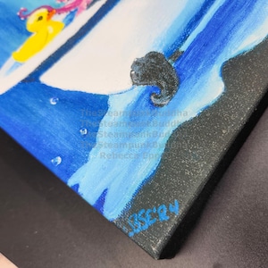 May include: An original painting on canvas featuring a whimsical scene with a yellow duck and a pink octopus on a white surface, set against a blue background. The artwork is signed by the artist, Rebecca Epperson.