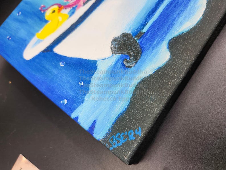 May include: An original painting on canvas featuring a whimsical scene with a yellow duck and a pink octopus on a white surface, set against a blue background. The artwork is signed by the artist, Rebecca Epperson.