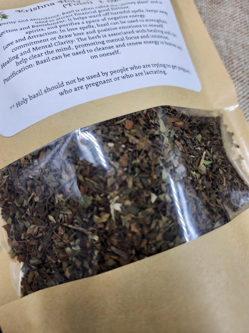 May include: A clear plastic bag filled with dried basil leaves, displayed on a brown paper background. The bag has a white label with text about the herb's properties. The text includes information about love, healing, and purification.