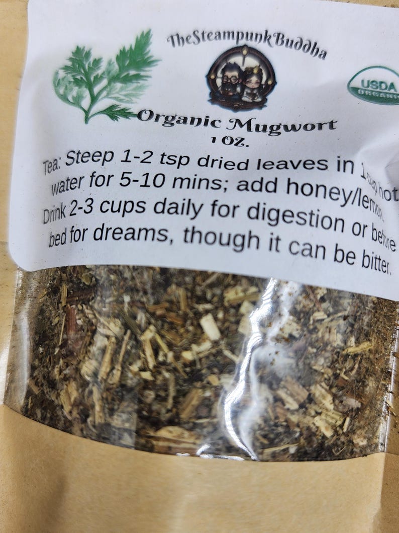 May include: A package of organic mugwort tea from The Steampunk Buddha. The label includes instructions for steeping the tea and a USDA organic seal. The tea is for digestion or before bed for dreams.