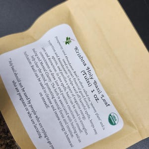 May include: A package of Krishna Holy Basil Leaf (Tulsi) 1 oz. The label includes information about the herb's uses for prosperity, protection, love, healing, and purification. The package has a USDA Organic seal.