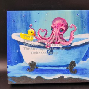 May include: A whimsical painting depicts a pink octopus in a white bathtub with black claw feet. A yellow rubber ducky sits on the tub's edge. The background is a gradient of blue, with bubbles and water splashes adding detail. The artwork is signed.