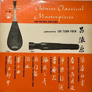 May include: A vintage record album cover featuring two traditional Chinese musical instruments, the pipa and the chin. The album is titled "Chinese Classical Masterpieces" and features the performer "Lui Tsun-Yuen". The album cover is orange with black and white text and images.