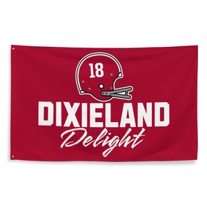 May include: A red flag with a white football helmet with the number 18 on it. The text "DIXIELAND Delight" is written in white below the helmet.