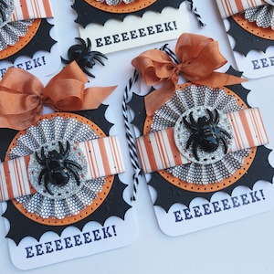 May include: Four Halloween-themed gift tags with black and orange spiderwebs, a black spider, and the text "EEEEEEEK!" on each tag.