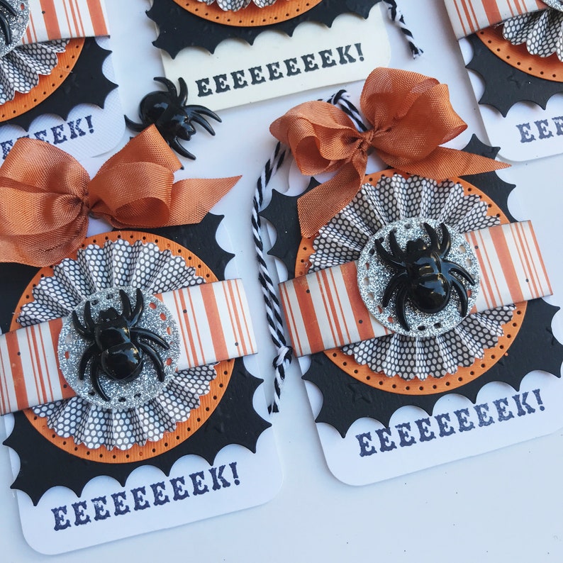 May include: Four Halloween-themed gift tags with black and orange spiderwebs, a black spider, and the text "EEEEEEEK!" on each tag.