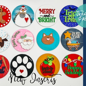 May include: A set of 12 colorful round wooden signs with various holiday and seasonal themes. The signs feature different designs, including a gingerbread man, a cat, a paw print, a Christmas tree, a Santa Claus, a cow, a worm, and a gingerbread house. The signs are perfect for decorating your home for any occasion.