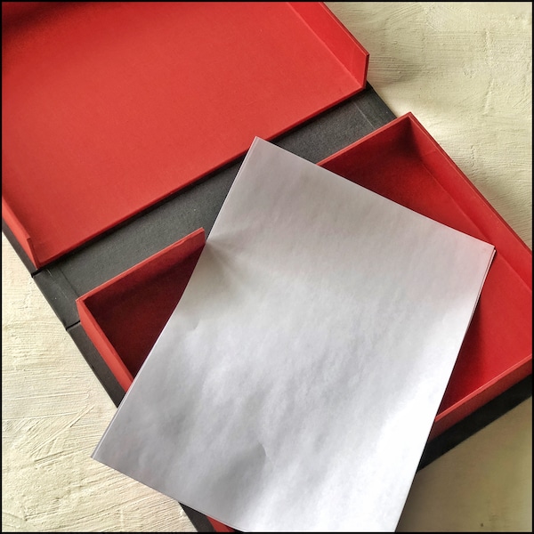 A4 Clamshell box hand bound in Black buckram and red book cloth | Solander box |