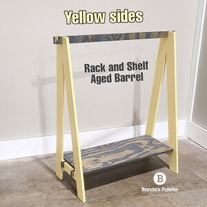 May include: A-frame rack and shelf with yellow sides and a shelf made of aged barrel wood. The text "Yellow sides" and "Rack and Shelf Aged Barrel" are visible on the rack.