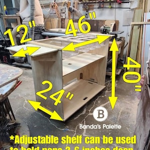 May include: A wooden shelf unit with adjustable shelves, measuring 46 inches wide, 40 inches tall, and 24 inches deep. The shelf unit is on a mobile base and has a label that says "Banda's Palette". The text "*Adjustable shelf can be used to hold pans 2-6 inches deep. To keep food cold." is also visible.