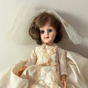 Mid-century 8&quot; doll, sleep eyes, neck swivels, arms move, stationary body, hard plastic, brunette hair, blue eyes