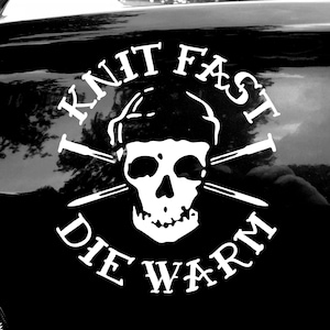 May include: Black and white sticker on a car with a skull and crossbones and the text "Knit Fast Die Warm".