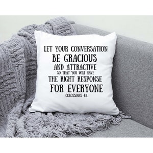May include: White throw pillow with black text that reads "Let your conversation be gracious and attractive so that you will have the right response for everyone. Colossians 4:6"
