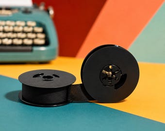 May include: Two black typewriter ribbon spools with a black ribbon extending between them. The spools are on a colorful background of teal, yellow, orange, and red. A teal typewriter is in the background.