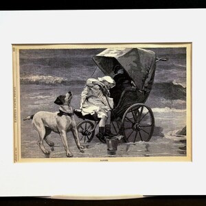 May include: Black and white illustration of a dog looking up at a carriage on a beach. A person is seated in the carriage, and another person is standing beside it. The image is framed with a white mat.