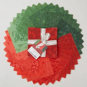 May include: A collection of red, green, and coral fabric squares arranged in a circular pattern. A bundle of red fabric squares is tied with a white ribbon and a tag that reads "Charm Squares". The fabrics feature floral patterns.