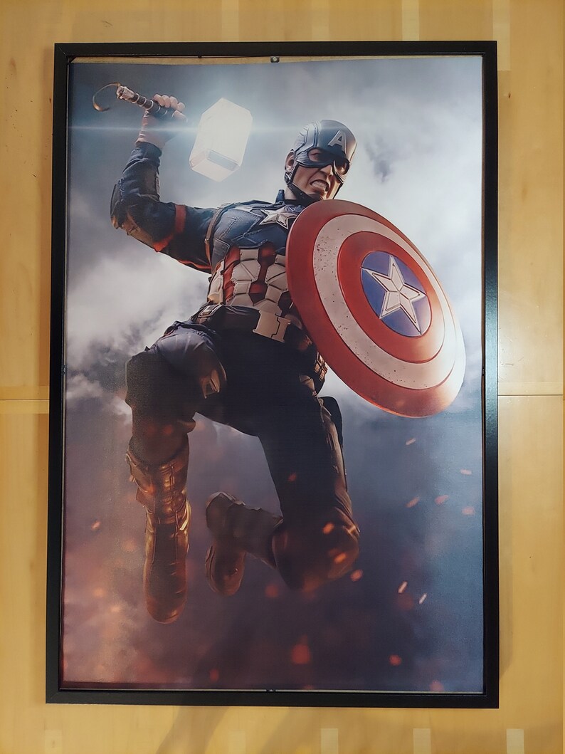 May include: A superhero in a blue, red, and white costume holding a hammer and a shield. The superhero is jumping in the air with a determined expression on their face. The background is a cloudy sky with a fiery glow.