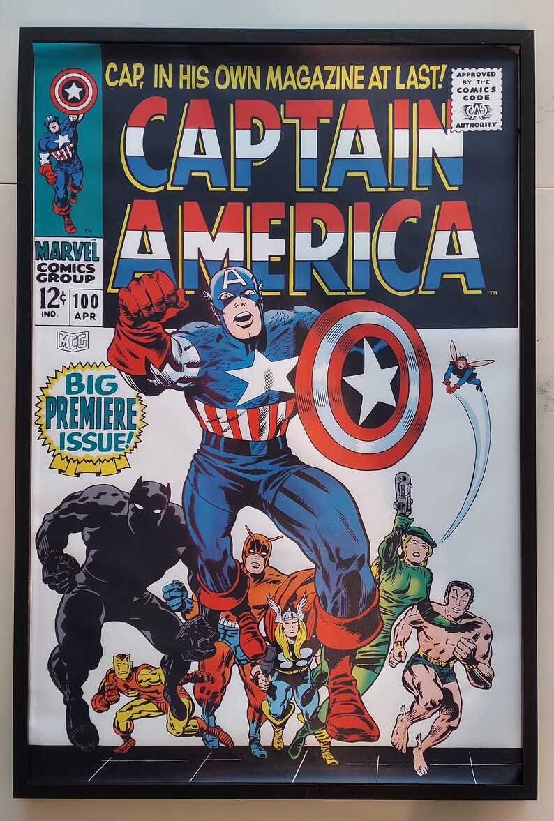 May include: Captain America comic book cover featuring Captain America in his red, white, and blue costume, standing with other superheroes, including Black Panther, Iron Man, and Thor. The cover text reads "CAPTAIN AMERICA" and "BIG PREMIERE ISSUE!"