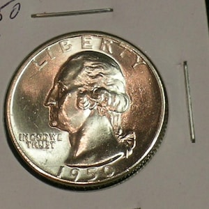 May include: A close-up of a 1950 S quarter coin. The coin features a profile of George Washington and the inscription "IN GOD WE TRUST." The word "LIBERTY" is at the top. The year "1950" is visible at the bottom.