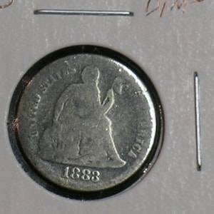 May include: A silver United States Half Dollar coin with the year 1883 inscribed on the face.