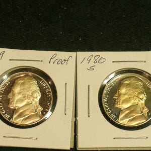 May include: Two gold-colored proof coins, one from 1979 and one from 1980, both featuring the profile of Andrew Jackson. The coins are displayed on white cards with the year and "S" mint mark printed on each.