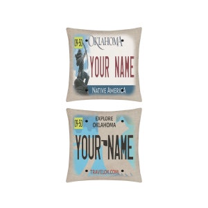 May include: Two beige pillowcases with a vintage Oklahoma license plate design. The top pillowcase features a Native American archer with the text "Oklahoma" and "Your Name" in red. The bottom pillowcase features the text "Explore Oklahoma" and "Your Name" in blue.