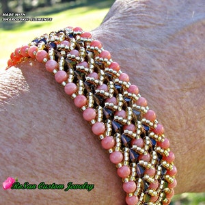 May include: A pink and gold beaded bracelet with a geometric pattern. The bracelet is made with Swarovski Elements and is labeled "RoSan Custom Jewelry".