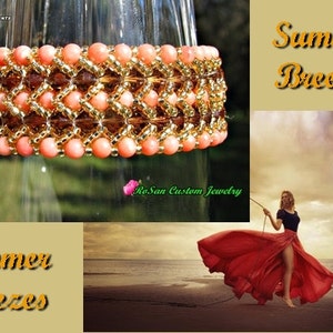 May include: A coral and gold beaded bracelet with a geometric design. The bracelet is displayed on a glass surface. The text "Summer Breezes" is visible in the image.