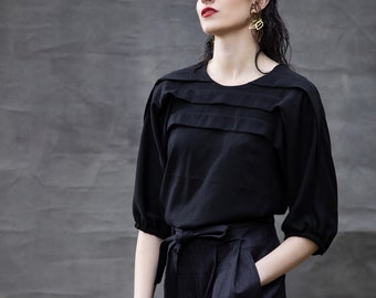 Black folded rayon top, buttons on back, half sleeve