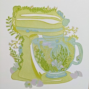 May include: A green stand mixer with a glass bowl filled with green and yellow floral designs. The mixer is decorated with green leaves and white flowers.