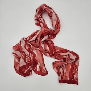 May include: A white ceramic mug with a black handle and the text "But First, Coffee" in a bold, black font. The mug is set against a neutral background, highlighting its simple design.