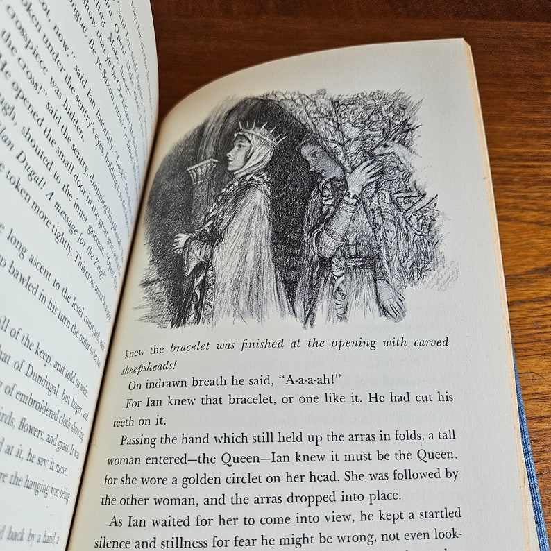 May include: A black and white illustration of a woman wearing a crown and a long robe, standing next to another woman wearing a long robe. The women are standing in front of a dark, leafy background. The text "A-a-a-ah!" is written below the image.