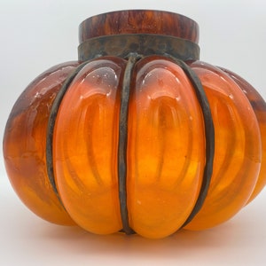 May include: Orange glass pumpkin-shaped lampshade with a metal frame.