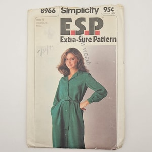 May include: Vintage Simplicity sewing pattern, number 8966, featuring a woman in a green dress. The pattern is labeled "ESP Extra-Sure Pattern" and includes the price of 95 cents. The date "7/30/79" is handwritten on the pattern.