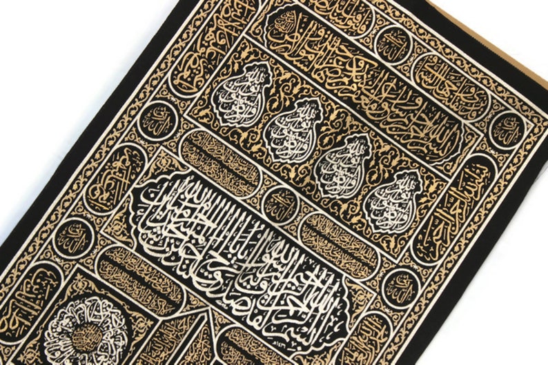 May include: Black fabric with gold and white Arabic calligraphy in a repeating pattern. The design features intricate floral motifs and geometric shapes.