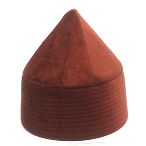 May include: A brown felt hat with a conical crown and a wide brim. The hat has a series of horizontal lines around the brim.