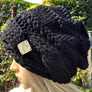 May include: Black knitted beanie with a gold leather tag that says "Rocking Pony".