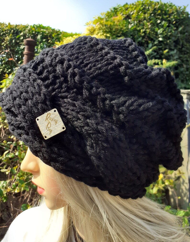 May include: Black knitted beanie with a gold leather tag that says "Rocking Pony".