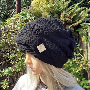 May include: Black knitted beanie with a small wooden tag that says "Racing Boy" in gold lettering.