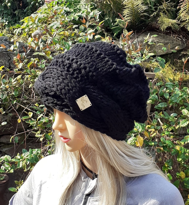 May include: Black knitted beanie with a small gold tag that says "Rainy Day".