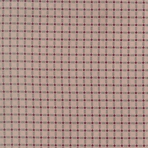 Peut inclure: Un tissu beige avec un motif répété d'étoiles rouges et de brins verts. Le motif est une grille d'étoiles et de brins.