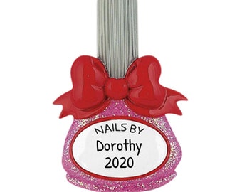 May include: Pink nail polish bottle Christmas ornament with a red bow and the text "Nails By Dorothy 2020".