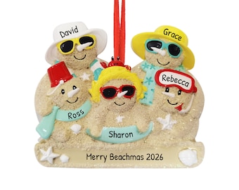 May include: A Christmas bauble depicting a family of five sand people wearing sunglasses and hats. The bauble is decorated with a red crab, seashells, and the text "Merry Beachmas 2026".