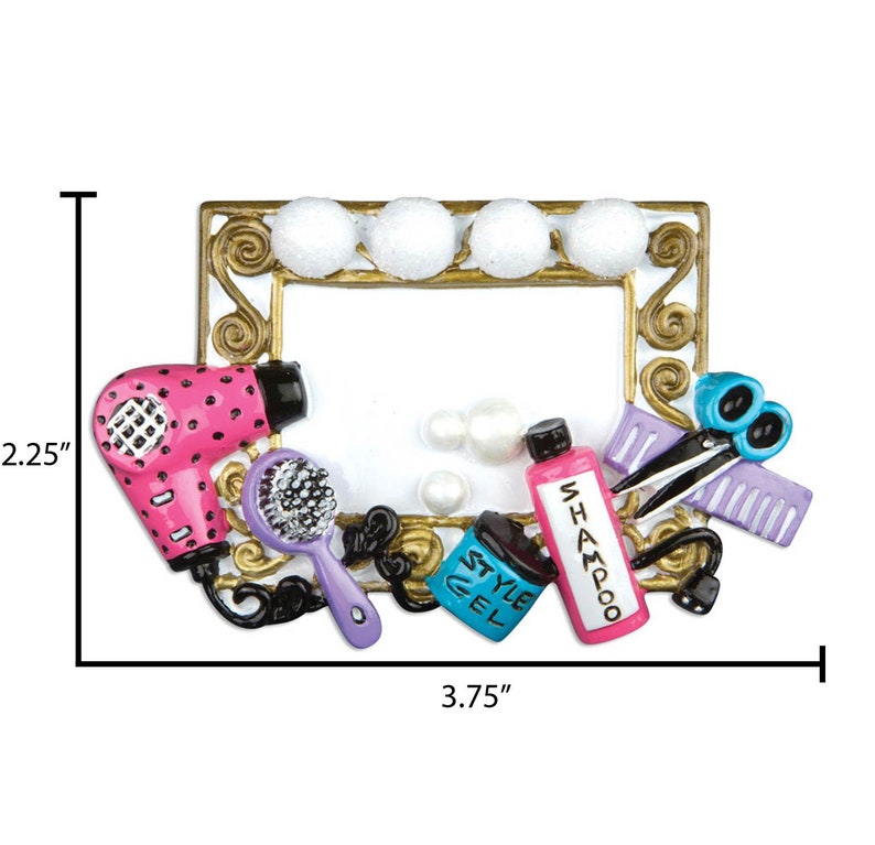 May include: A gold-colored picture frame with a white background and a variety of hair styling tools, including a pink hair dryer, a purple hairbrush, a bottle of shampoo, a bottle of styling gel, a pair of scissors, and a purple comb. The frame is 3.75 inches wide and 2.25 inches tall.