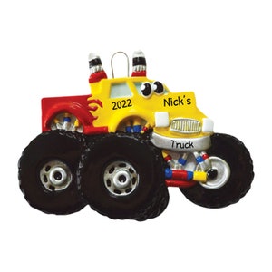 May include: Yellow and red monster truck Christmas ornament with the text "Nick's Truck" and "2022" on the front.