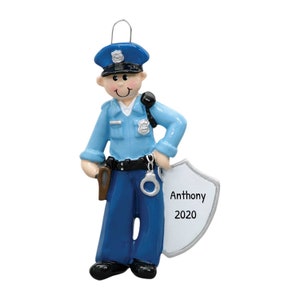 May include: A blue and white police officer Christmas ornament with a shield that says "Anthony 2020".