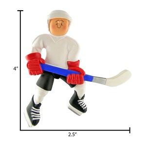 May include: A white hockey player ornament with a blue and silver hockey stick, red gloves, and black skates. The ornament is 4 inches tall and 2.5 inches wide.