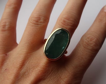 Ring i 9 karat gult guld, oval grön ädelsten, iögonfallande bezel