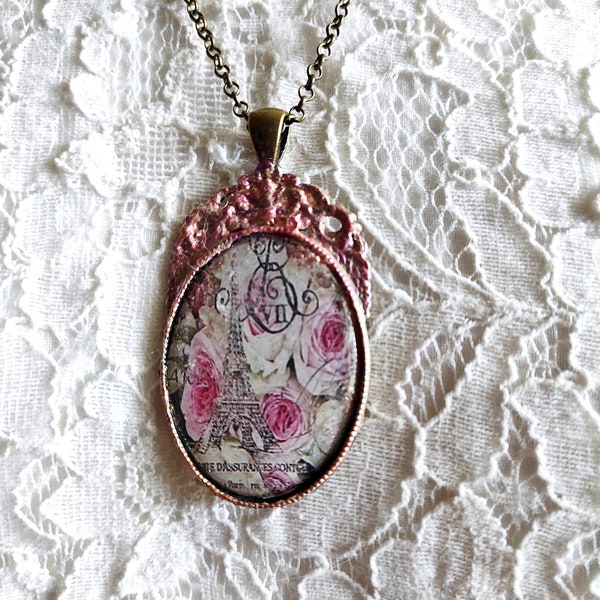 Shabby chic Paris souvenir necklace, the Eiffel Tower or "the iron lady" surrounded by white roses with a pink heart